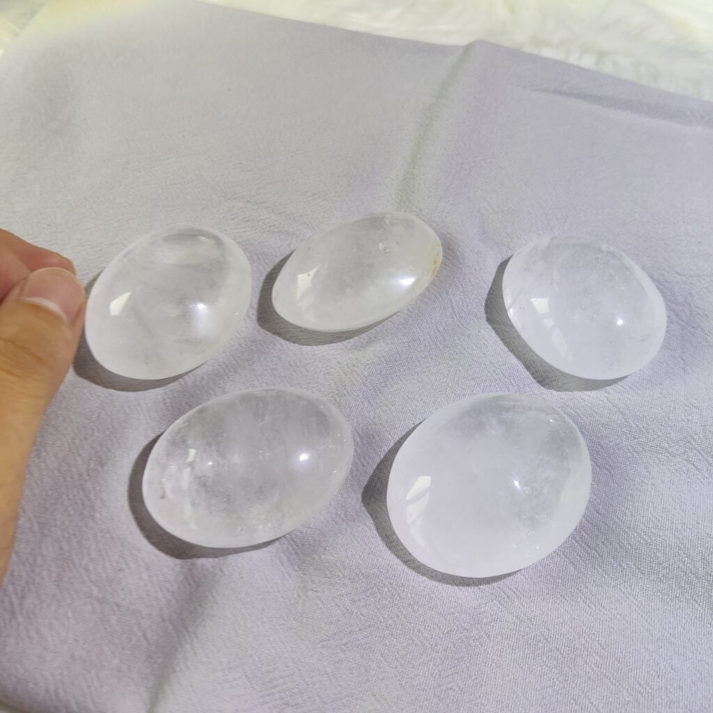 Clear quartz palm stones shown together