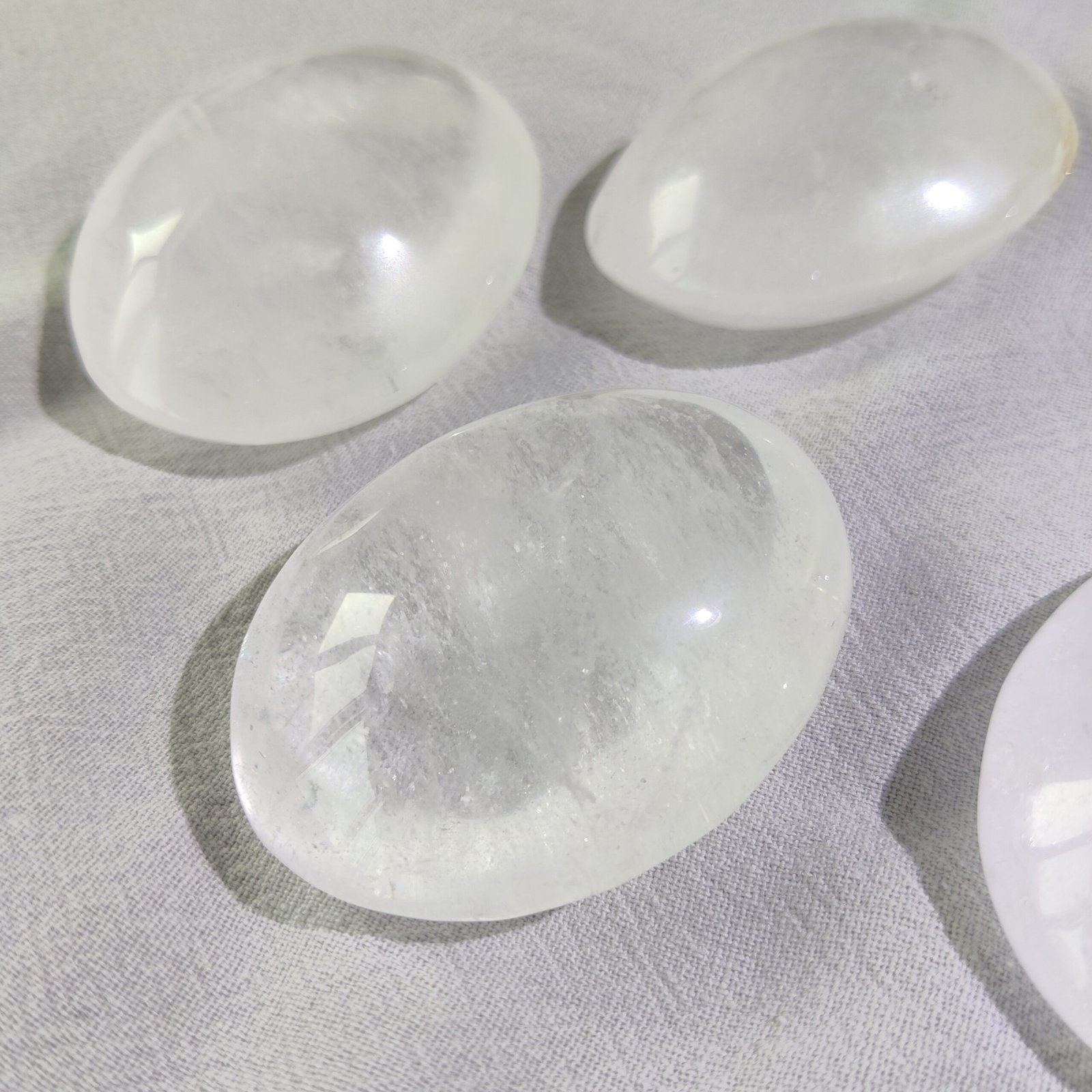 Close-up of polished clear quartz palm stones